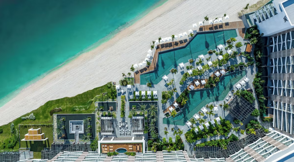 A stunning aerial view of Waldorf Astoria Cancun, showcasing its beachfront location, infinity pools, and lush tropical landscape.