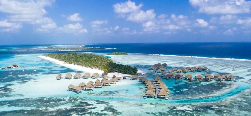 Luxurious overwater villa at The St. Regis Maldives Vommuli Resort with panoramic ocean views, perfect for an exclusive tropical getaway.