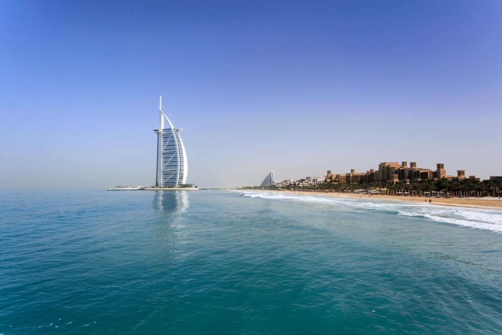 View of Burj Al Arab and Dubai coastline on a clear day with turquoise waters