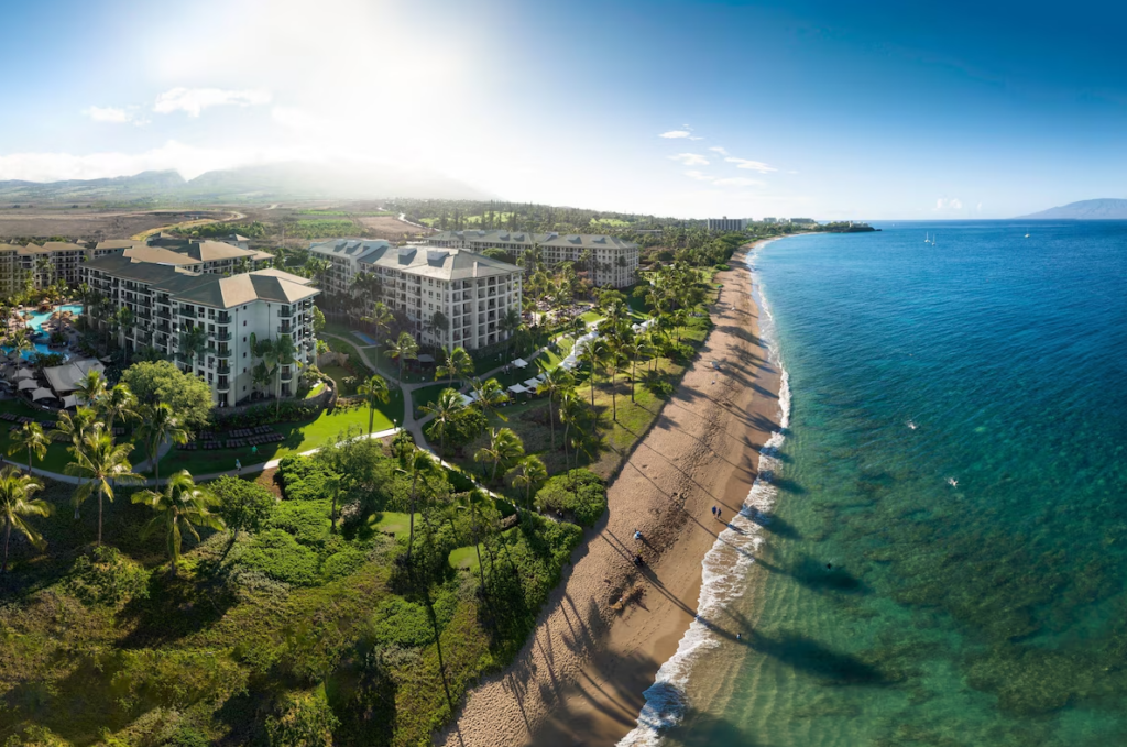 Aerial view of The Westin Ka'anapali Ocean Resort North, Maui, showing the beachfront, ocean, and resort buildings under a sunny sky.