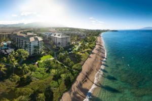 Aerial view of The Westin Ka'anapali Ocean Resort North, Maui, showing the beachfront, ocean, and resort buildings under a sunny sky.